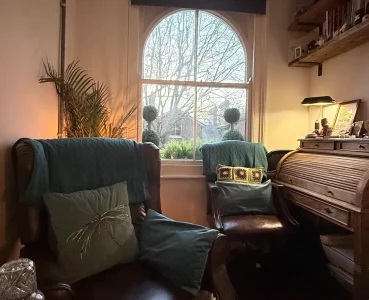 Counselling room at Deep Roots Counselling Service in Southend-on-Sea with comfortable chair, warm lighting and calm therapy space